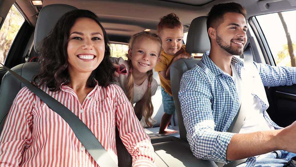 Happy family in car on road trip